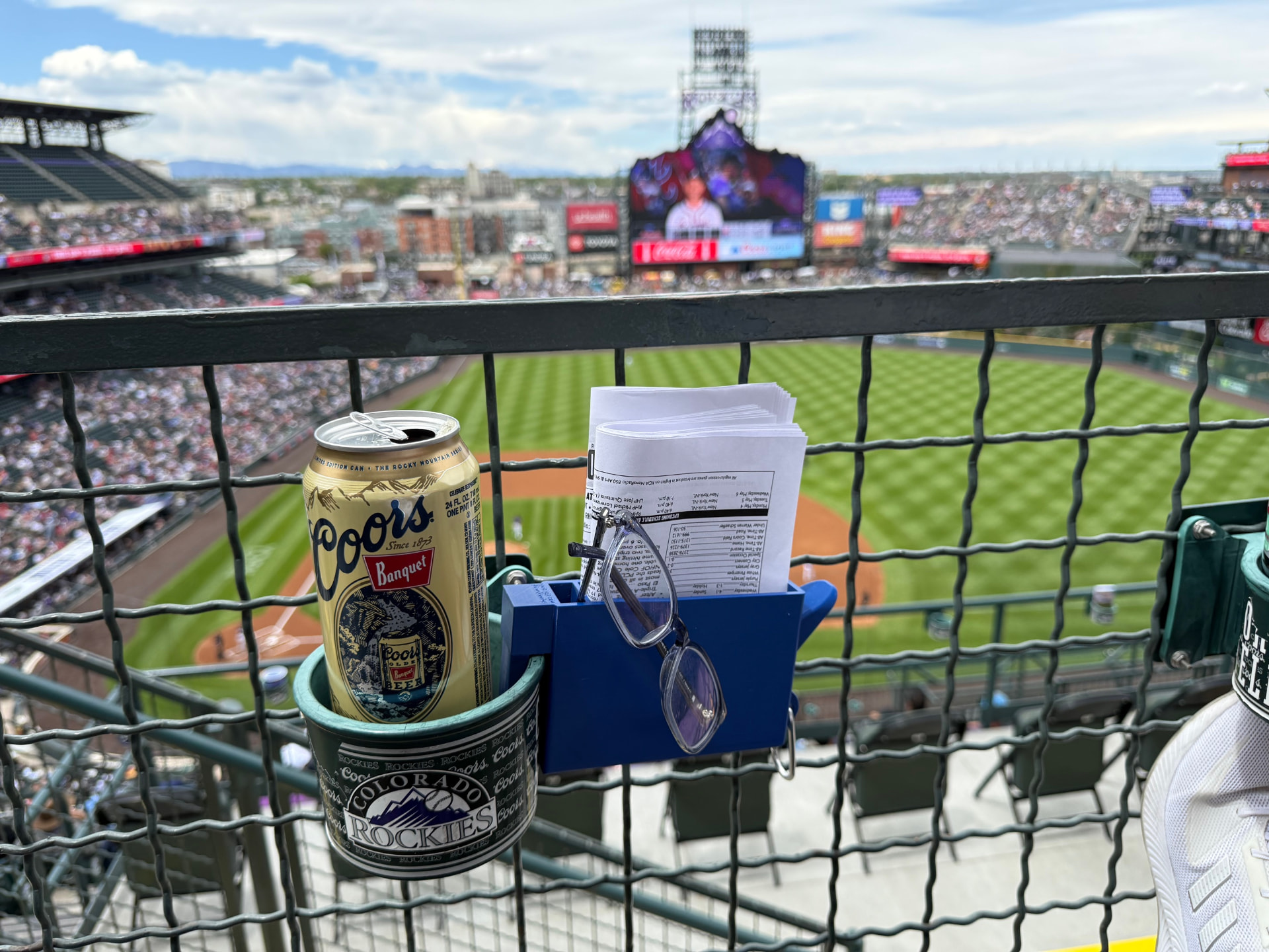 SNAC-KLIP clipped beside a stadium cup holder at Coors Field